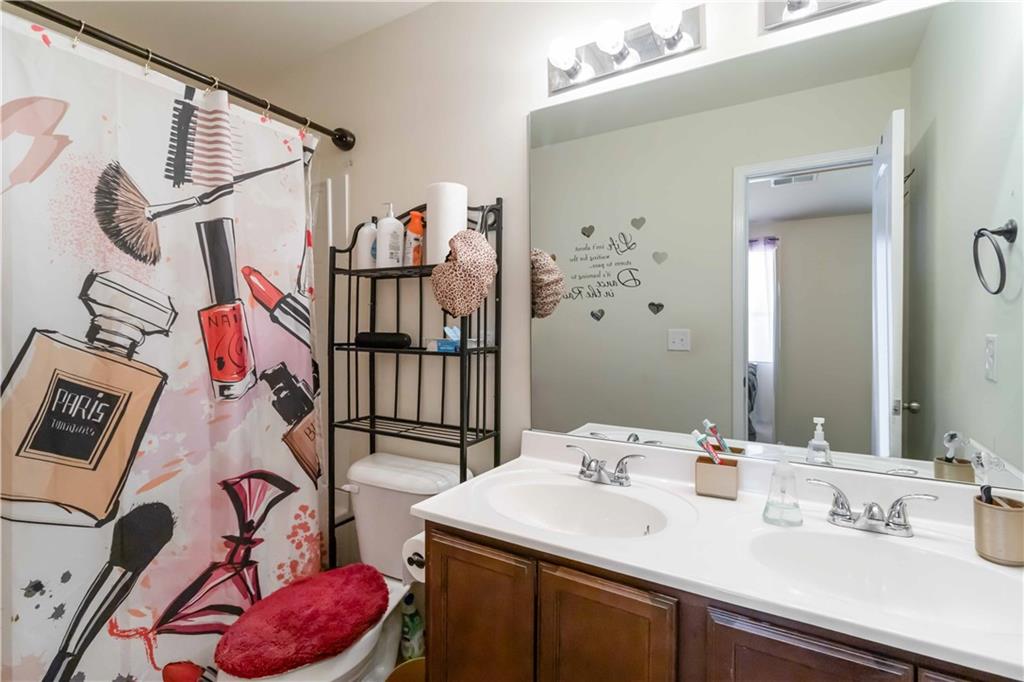 5622 Laurel Ridge Drive Atlanta, GA 30344 - Photo 12 of 23 a bathroom with a sink vanity and mirror