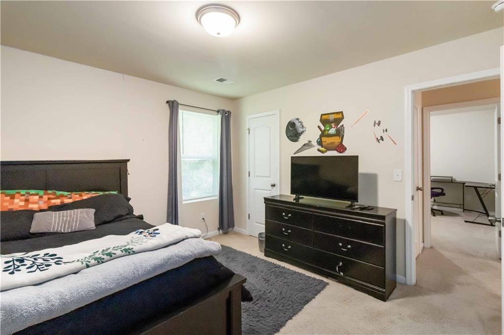 5622 Laurel Ridge Drive Atlanta, GA 30344 - Photo 13 of 23 a bedroom with a bed and a flat screen tv