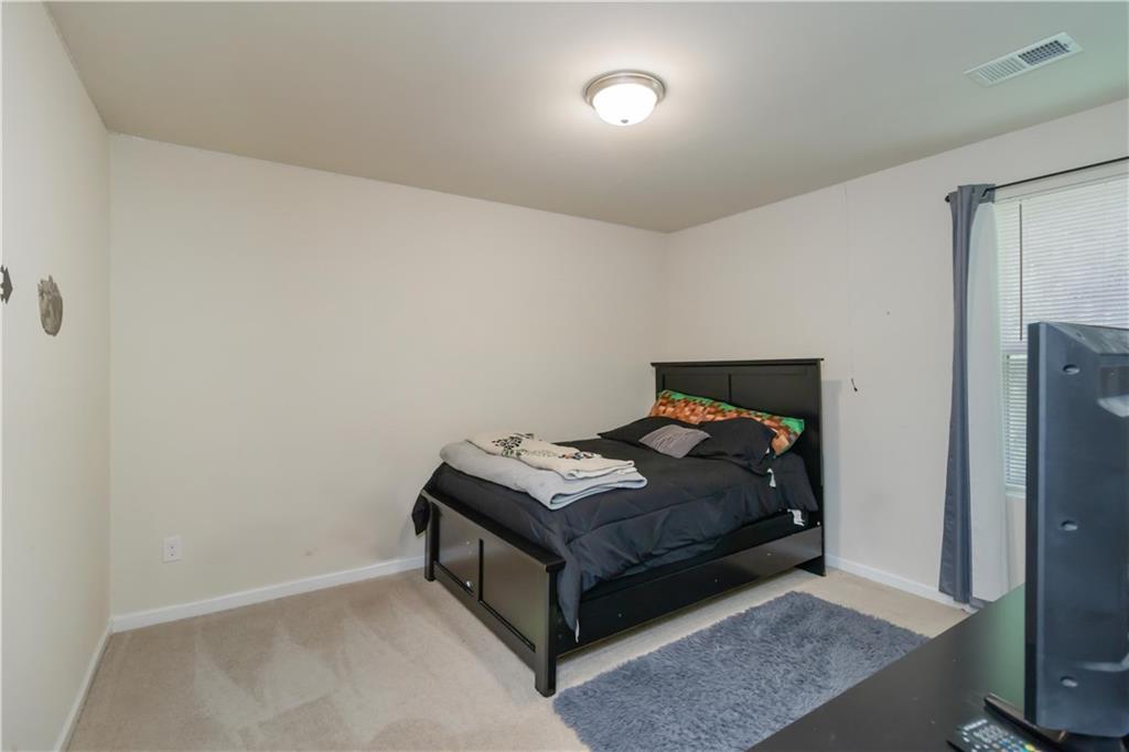 5622 Laurel Ridge Drive Atlanta, GA 30344 - Photo 14 of 23 a room with a bed and a mirror