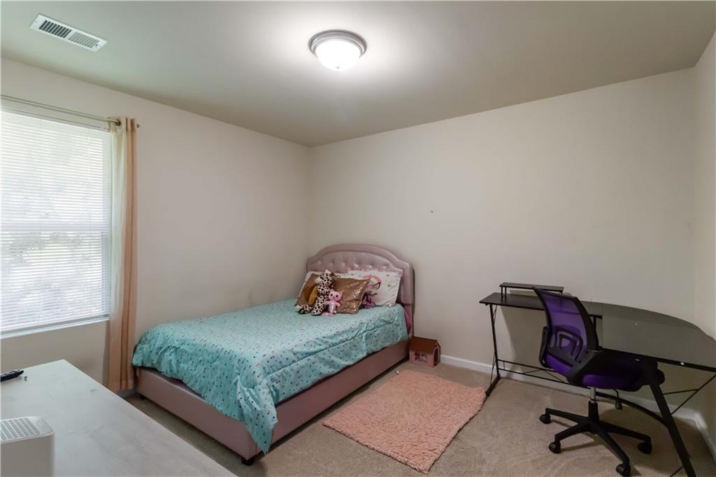 5622 Laurel Ridge Drive Atlanta, GA 30344 - Photo 16 of 23 a bedroom with a bed a table and chair