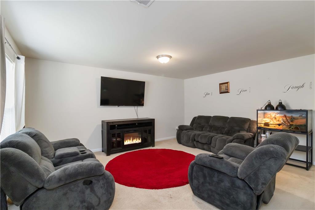 5622 Laurel Ridge Drive Atlanta, GA 30344 - Photo 6 of 23 a living room with furniture a flat screen tv and a fireplace