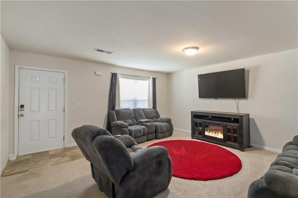 5622 Laurel Ridge Drive Atlanta, GA 30344 - Photo 8 of 23 a living room with furniture flat screen tv and a fireplace