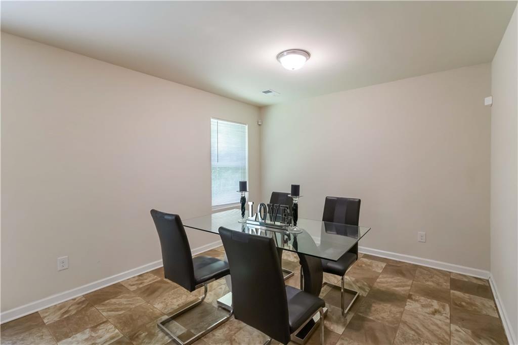 5622 Laurel Ridge Drive Atlanta, GA 30344 - Photo 9 of 23 a view of a dining room with furniture and wooden floor
