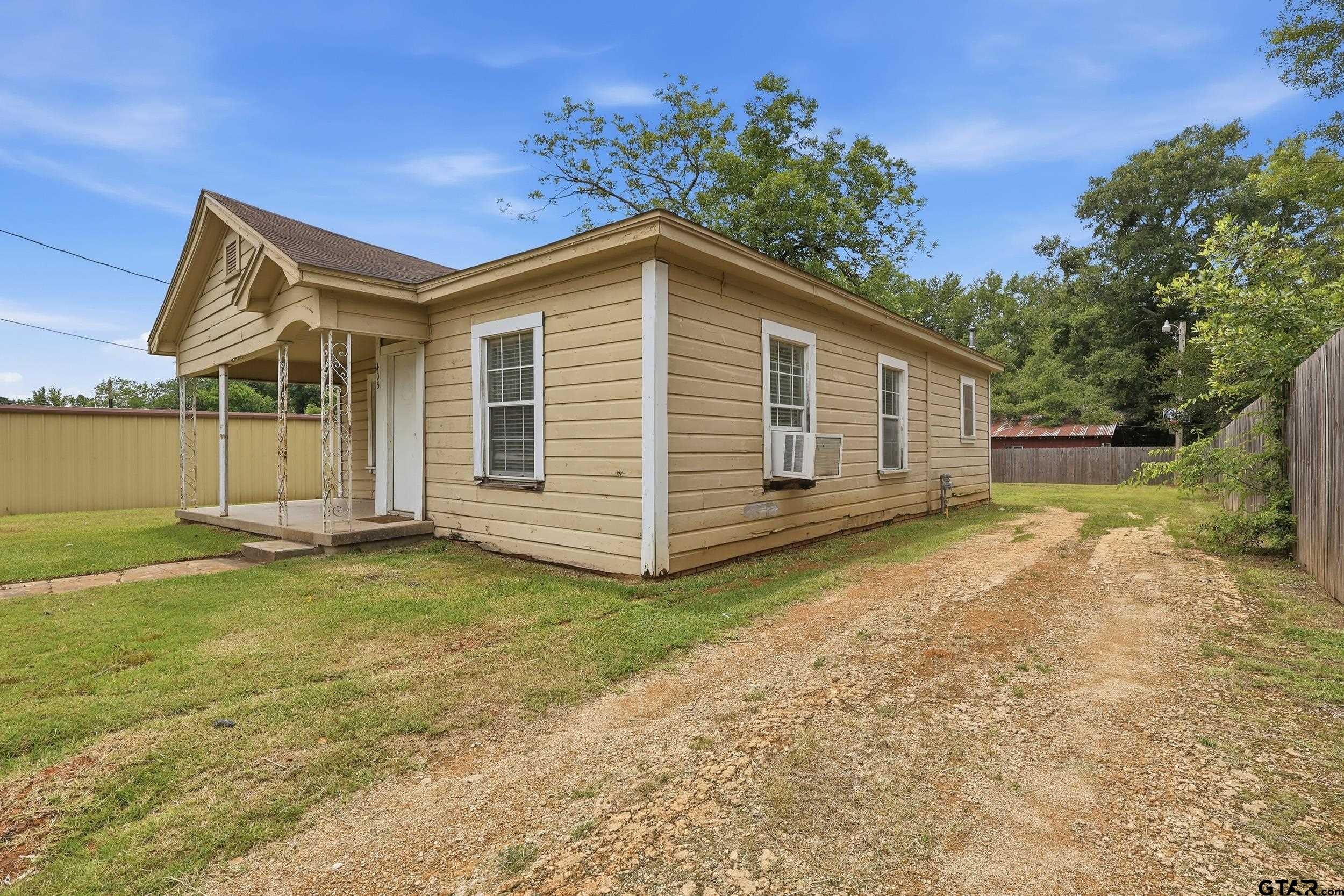 405 Rusk Street Pittsburg, TX 75686 - Photo 7 of 33 a view of a house with a yard