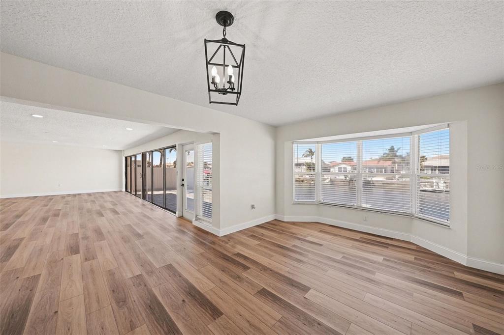 5041 Cabrilla Court New Port Richey, FL 34652 - Photo 20 of 43 an empty room with wooden floor and windows