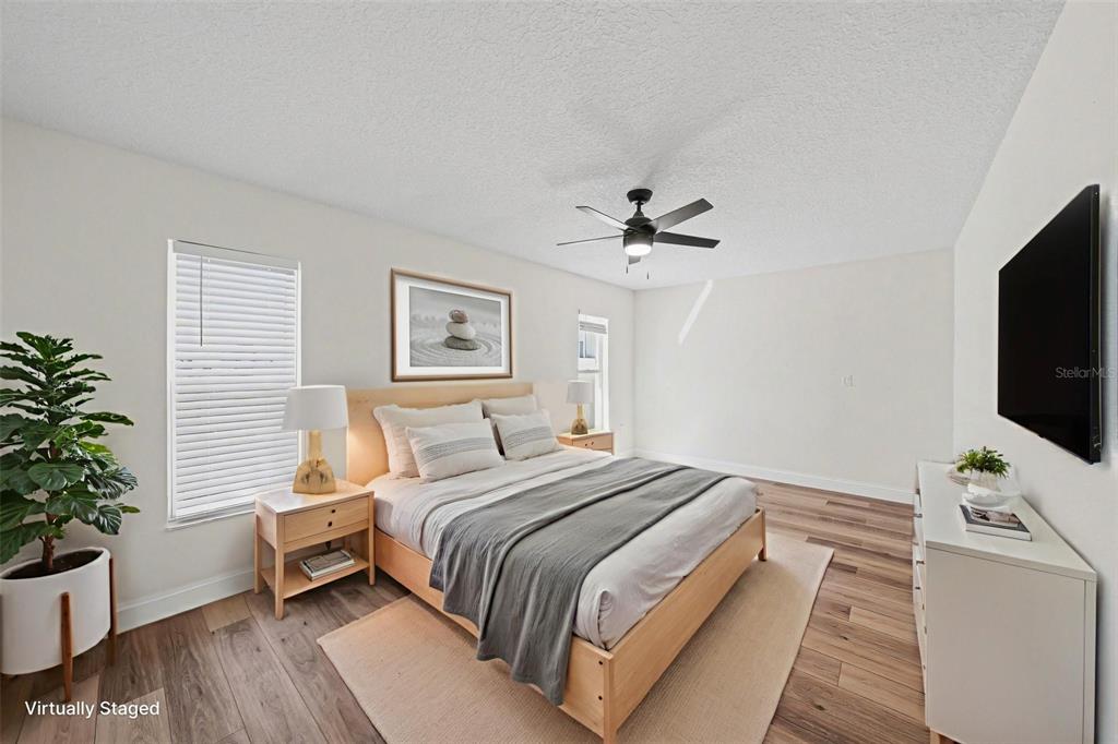 5041 Cabrilla Court New Port Richey, FL 34652 - Photo 24 of 43 a bedroom with a bed and a flat screen tv