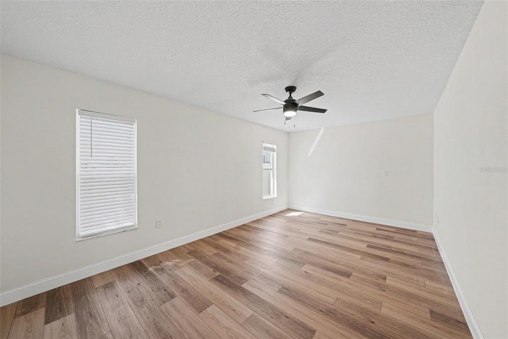 5041 Cabrilla Court New Port Richey, FL 34652 - Photo 25 of 43 wooden floor in an empty room with a window
