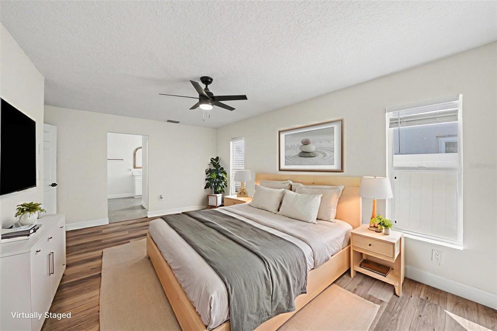 5041 Cabrilla Court New Port Richey, FL 34652 - Photo 26 of 43 a bedroom with a bed and a flat screen tv