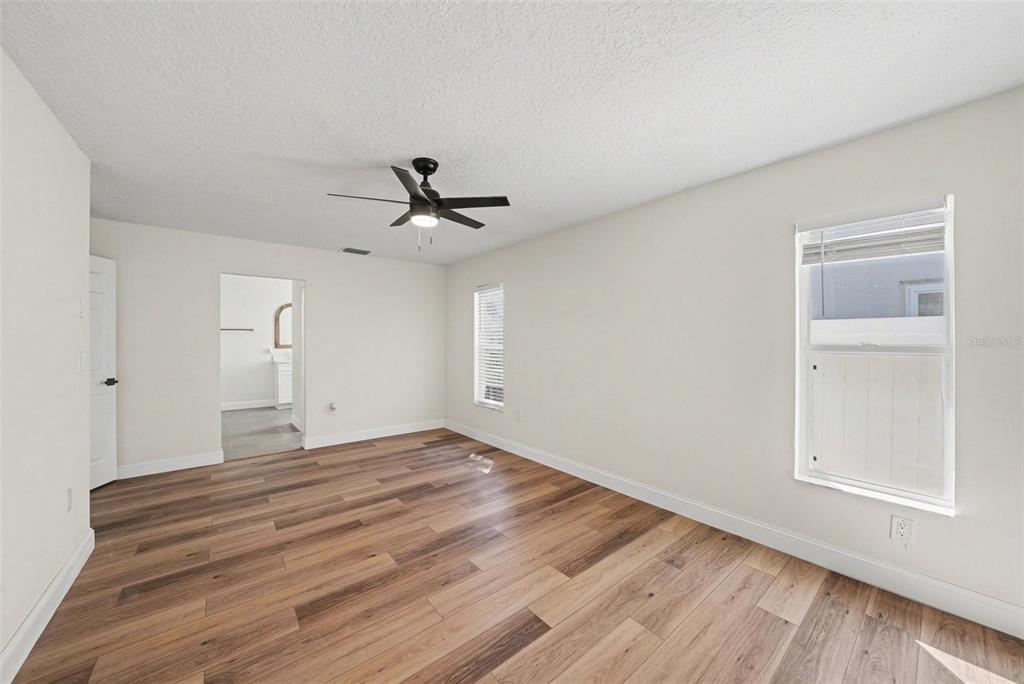 5041 Cabrilla Court New Port Richey, FL 34652 - Photo 27 of 43 a view of room with wooden floor and ceiling fan