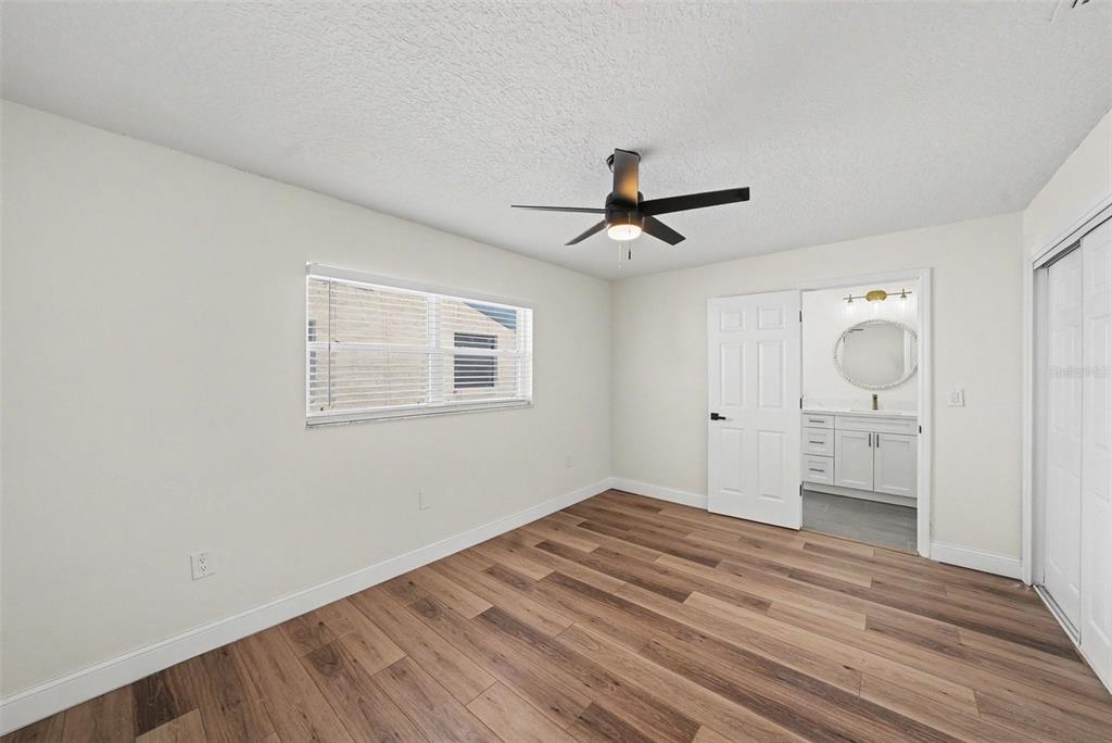 5041 Cabrilla Court New Port Richey, FL 34652 - Photo 31 of 43 a view of empty room with wooden floor and fan