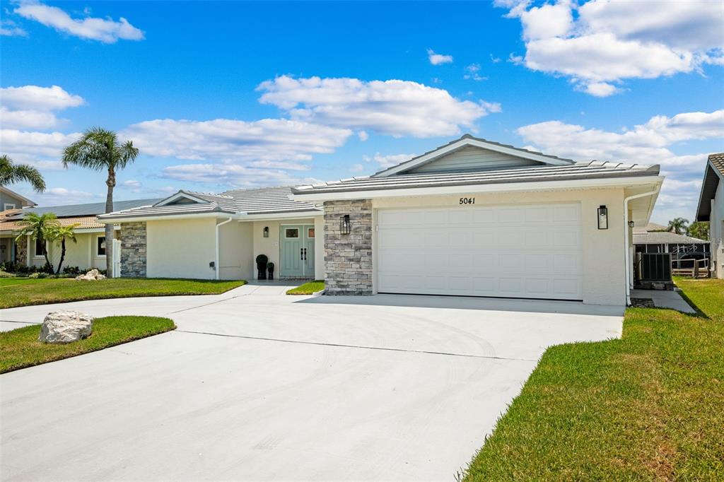 5041 Cabrilla Court New Port Richey, FL 34652 - Photo 5 of 43 a front view of a house with a yard and garage