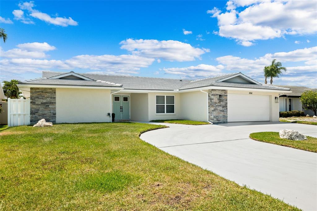 5041 Cabrilla Court New Port Richey, FL 34652 - Photo 6 of 43 a front view of a house with a yard and garage