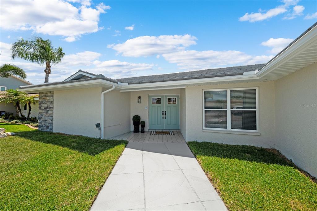 5041 Cabrilla Court New Port Richey, FL 34652 - Photo 7 of 43 a front view of a house with a yard and garage