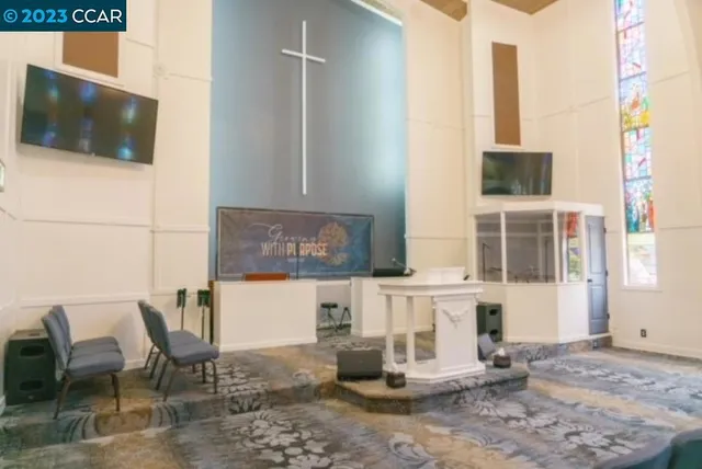 a living room with furniture and large windows