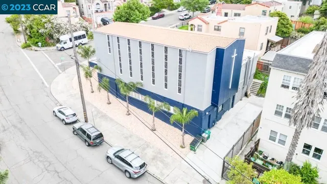 an aerial view of a house with a mountain