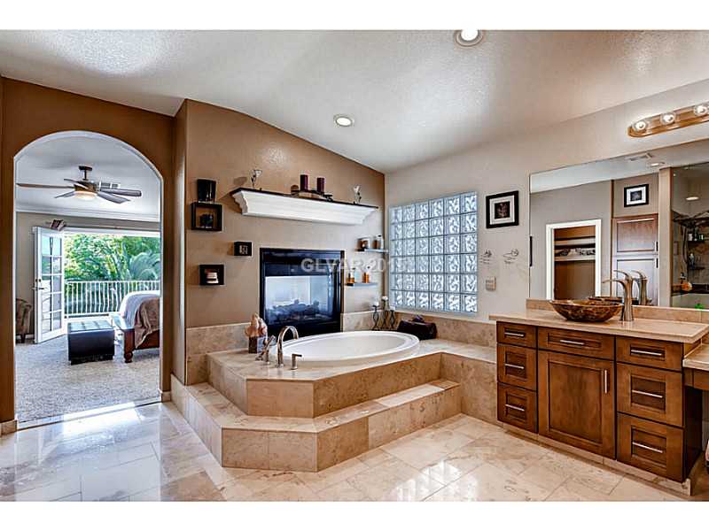 265 Violet Note Street Henderson, NV 89074 - Photo 12 of 20 Master Bath/Spa. Double sided fireplace between Master Bath and Master Bedroom