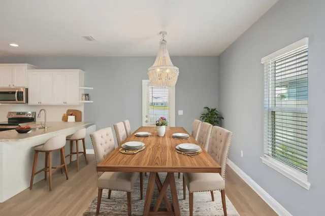 a kitchen with cabinets appliances a sink and a window