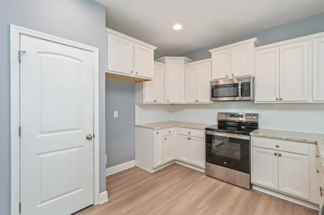 an empty room with windows and closet