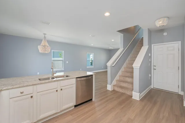 a bathroom with a granite countertop double vanity sink a mirror and shower