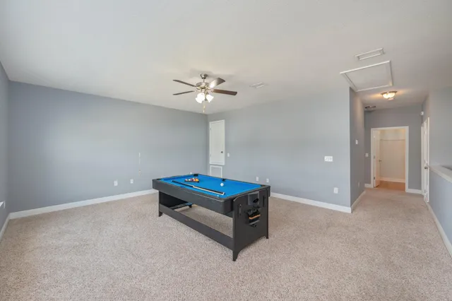 a bathroom with a granite countertop double vanity sink a mirror and a bathtub