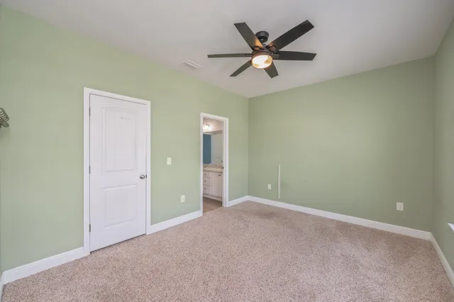 a view of an empty room with a ceiling fan