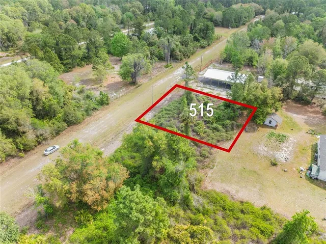 a view of a sign board in the middle of a yard