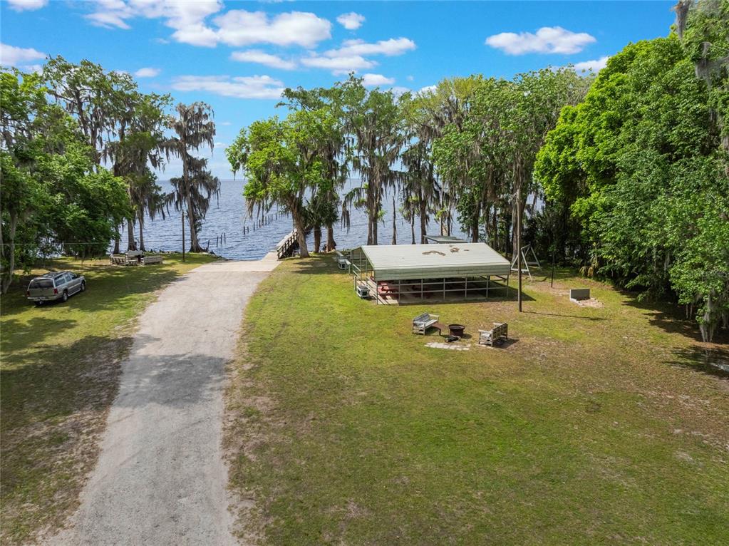 515 Gardenia Avenue Georgetown, FL 32139 - Photo 11 of 25 a view of a swimming pool with a yard and large trees