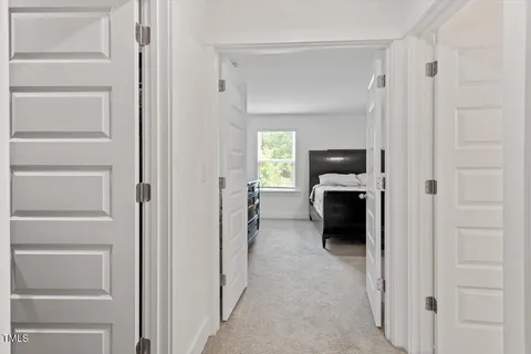 a view of walk in closet with clothes