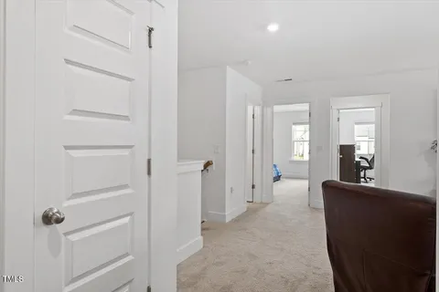 a living room with furniture and a chair