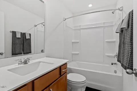 a bedroom with a bed next to a window