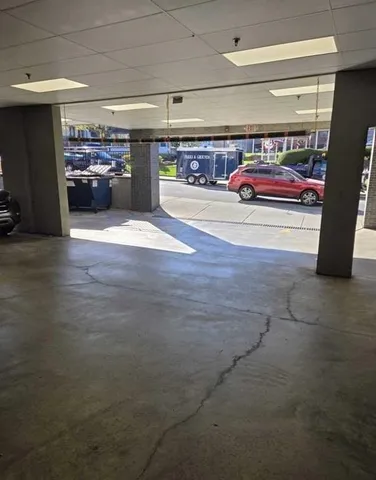 a view of parking garage with cars