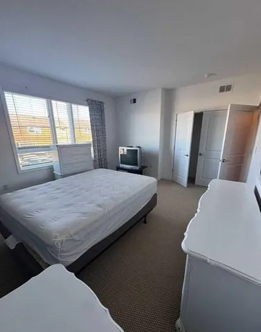 a bedroom with a bed and window