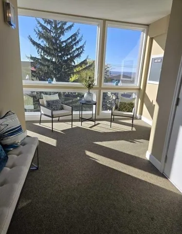 a view of workspace with furniture and window