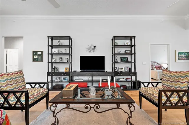 a dining room with furniture a chandelier and wooden floor