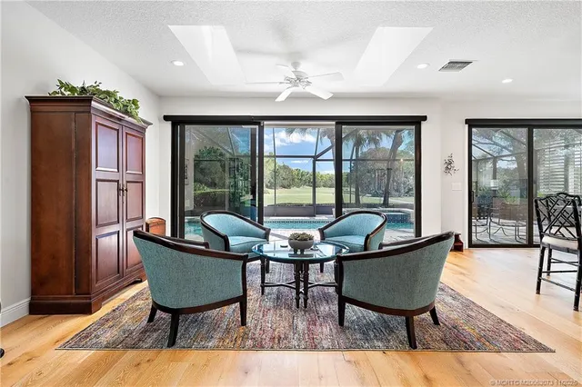 a living room with furniture and a floor to ceiling window