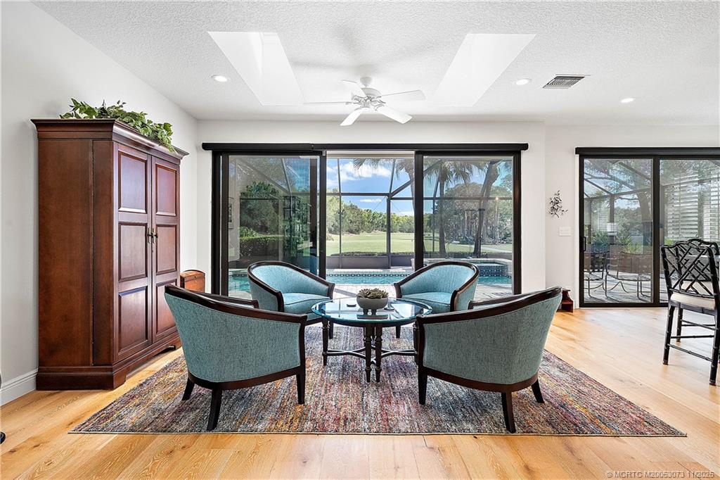 3501 Southeast Putnam Court Stuart, FL 34997 - Photo 12 of 58 a dining room with furniture a chandelier and wooden floor