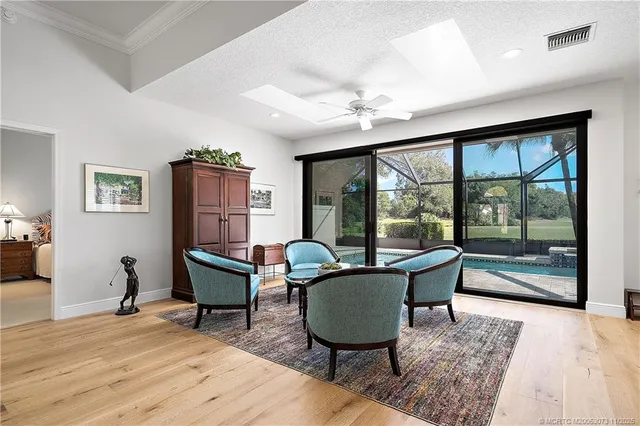 a open kitchen with stainless steel appliances granite countertop a stove a sink dishwasher a dining table and chairs with wooden floor