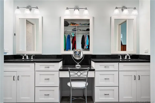 a bathroom with a granite countertop shower