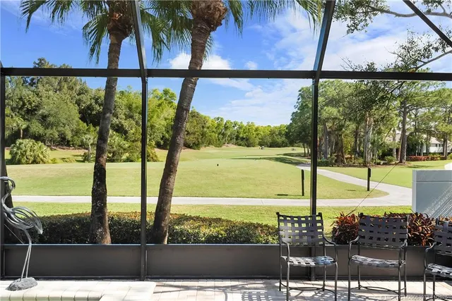 an aerial view of a house with a yard and lake view