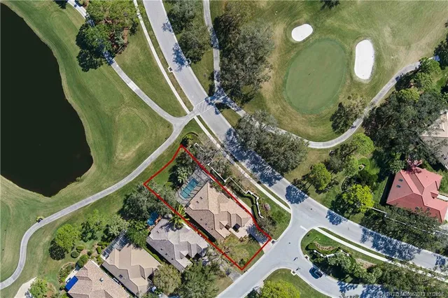 a front view of a house with a garden and yard