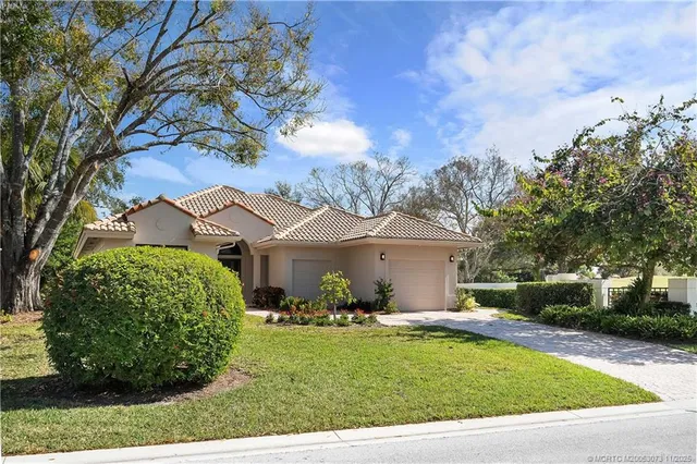 an aerial view of green landscape with trees houses and lake view