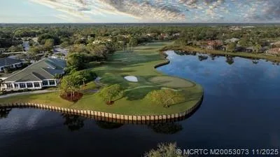 a living room with furniture and floor to ceiling windows