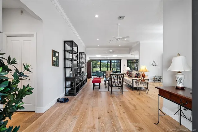 a living room with furniture and a view of kitchen