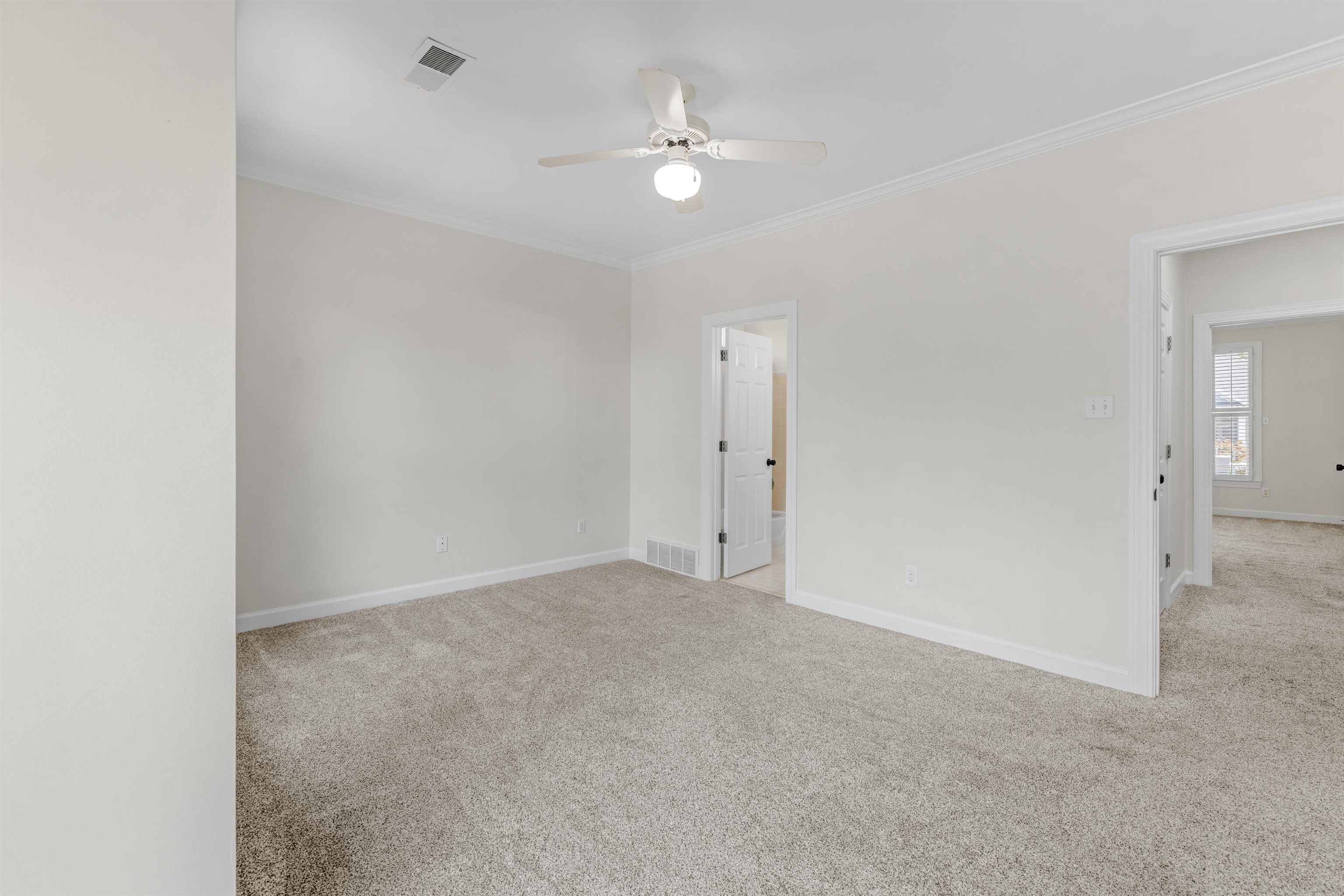 921 Harbor View Drive Memphis, TN 38103 - Photo 7 of 33 Spacious room featuring new carpet, neutral wall colors, crown molding, a ceiling fan, and white trim