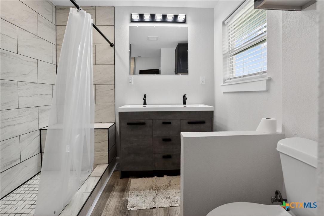 2539 County Road 347 Loop Gause, TX 77857 - Photo 11 of 25 a bathroom with a toilet sink and mirror