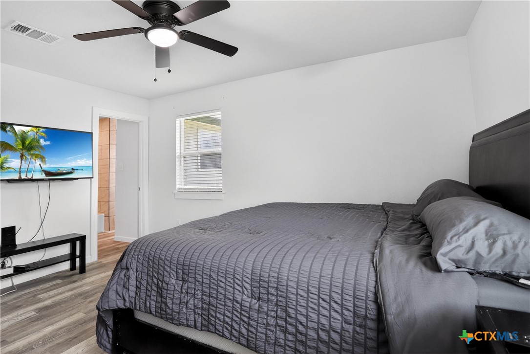 2539 County Road 347 Loop Gause, TX 77857 - Photo 14 of 25 a bedroom with a bed and a chandelier