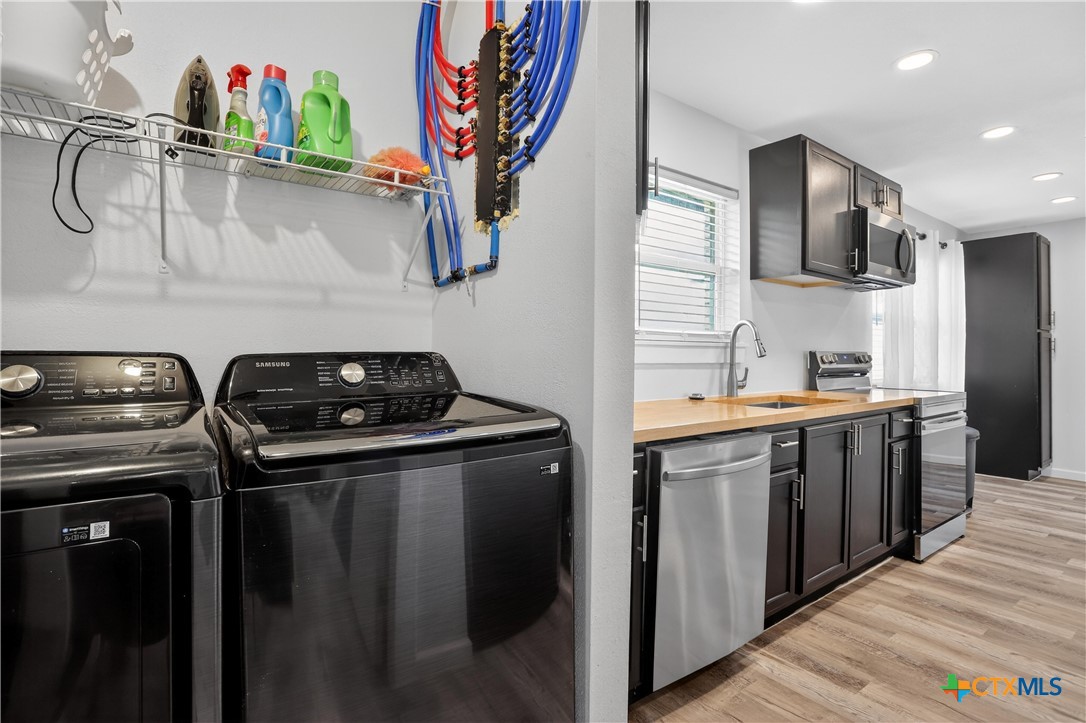 2539 County Road 347 Loop Gause, TX 77857 - Photo 22 of 25 a kitchen with stainless steel appliances granite countertop a refrigerator and a sink