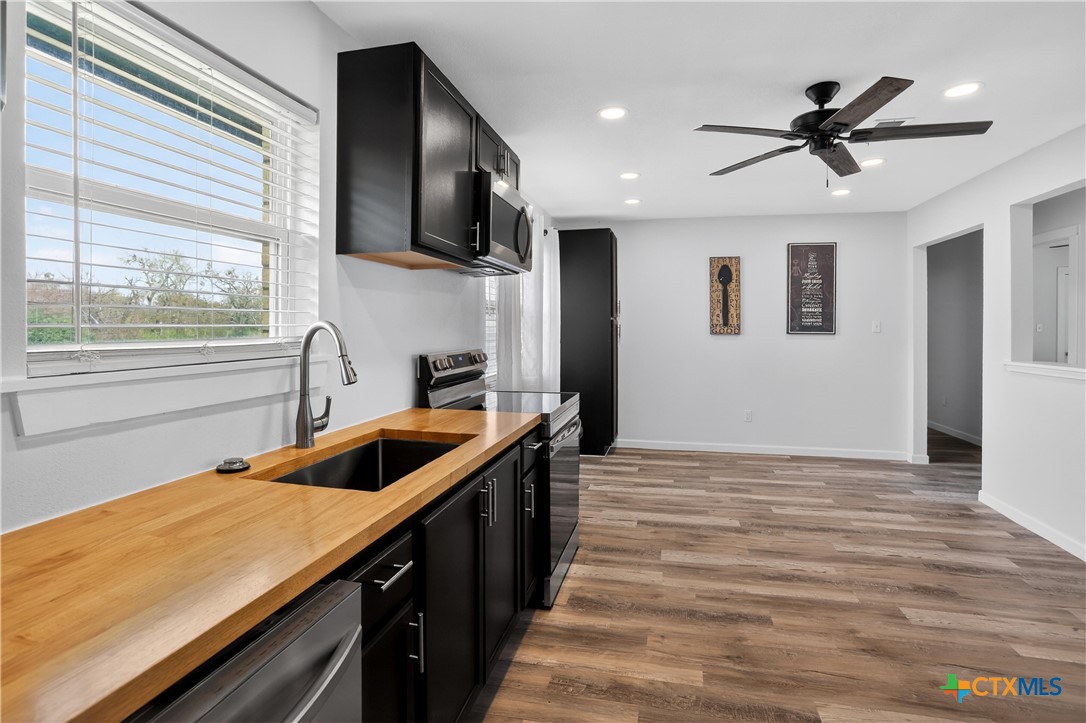 2539 County Road 347 Loop Gause, TX 77857 - Photo 5 of 25 a kitchen with stainless steel appliances granite countertop a sink and a microwave