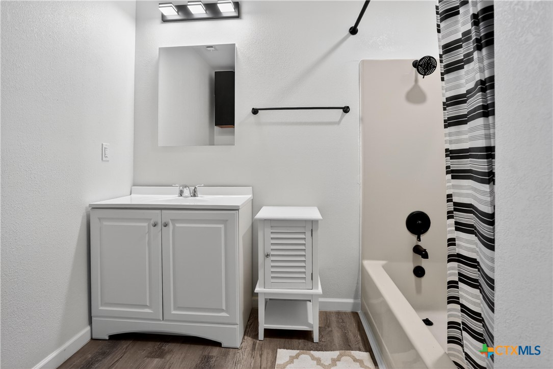 2539 County Road 347 Loop Gause, TX 77857 - Photo 9 of 25 a bathroom with a sink a toilet a shower and a mirror
