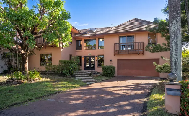 a front view of a house with garden